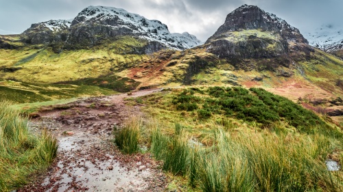 A stony path leading up to mountains. 