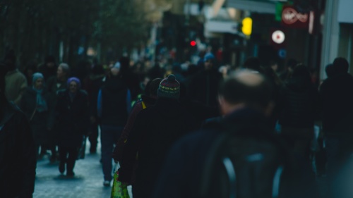 People walking on a crowded city street.