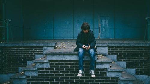 A young boy using a mobile device.