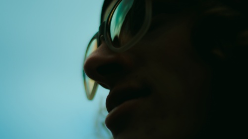 Upclose photo of a person wearing glasses.