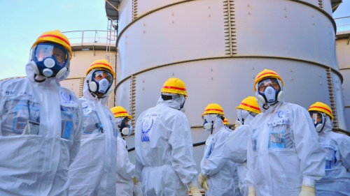 A team of IAEA experts check out water storage tanks.