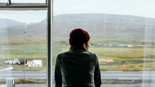 A woman looking out a window.