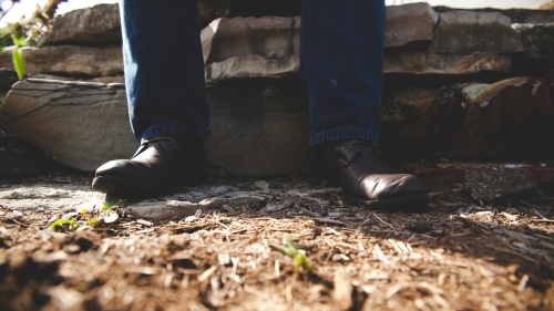 A persons shoes on the ground/