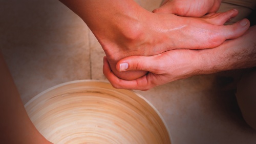 A person washing another person's foot.