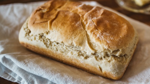 A loaf of bread on a cloth napkin.