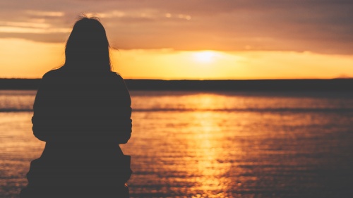 A person watching a sunset.