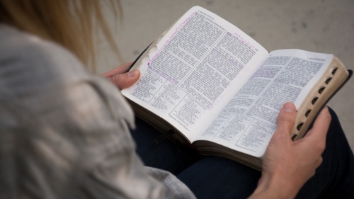 A woman reading a Bible.