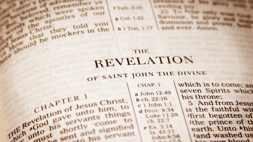 A Bible opened to the book of Revelation.
