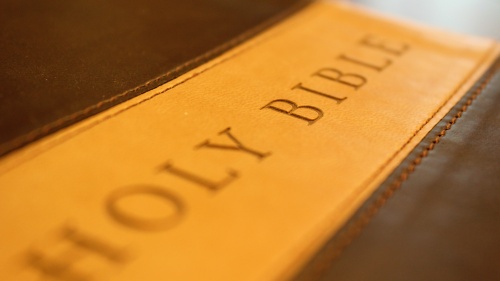 A Bible with "Holy Bible" on a leather cover.