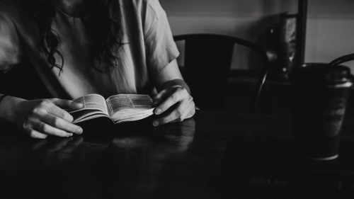 A young woman reading a Bible.