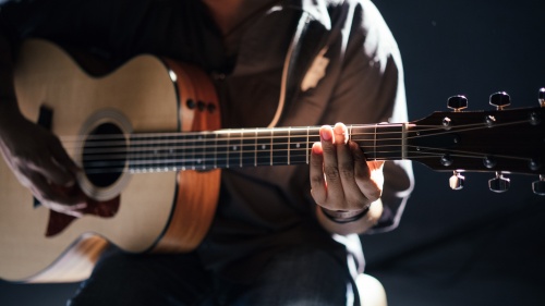 A person playing a guitar.