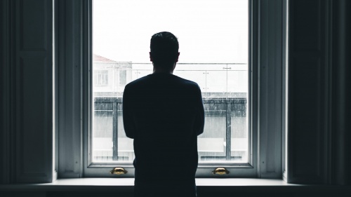 A man looking out a window.