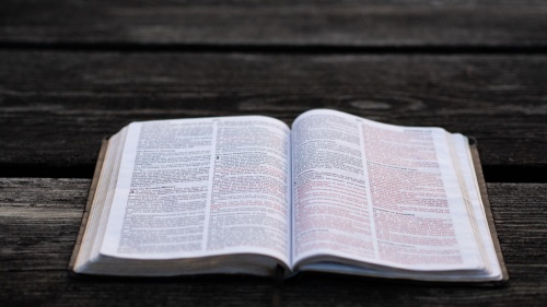 An open Bible laying on a table.