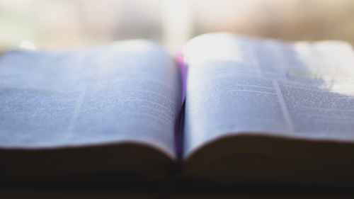 An open Bible laying on a table.