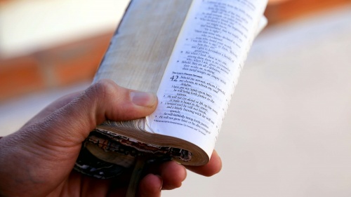 A man holding a Bible in his hand.