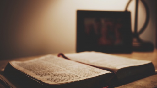 An open Bible laying on a table.