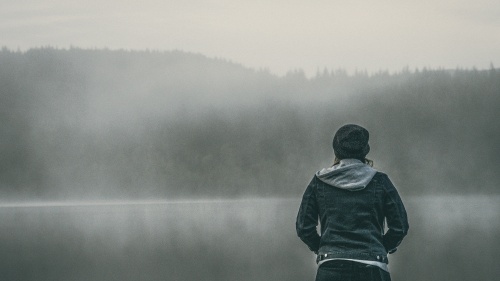 A person standing by a body of water.