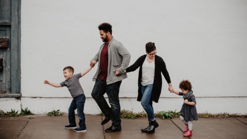 A family walking down a sidewalk. 