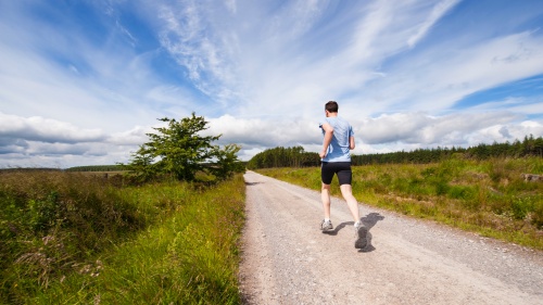 Man running on road.