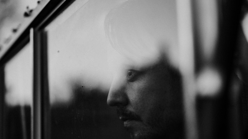 A man looking through a window.