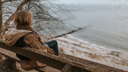 A woman sitting on a bench.