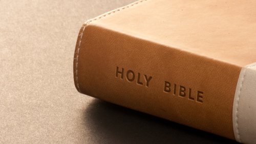 A Bible laying on a table.