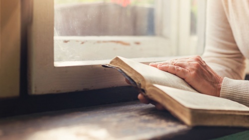 A woman reading a Bible.