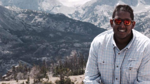 portrait of Jacob Mammen in front of a mountainous backdrop