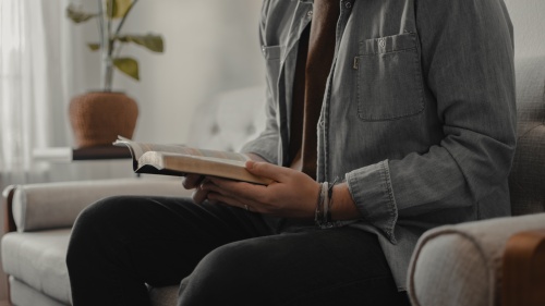 A person reading a Bible.