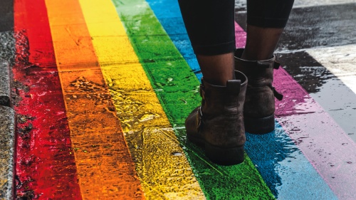 Pride flag color painted on a sidewalk.