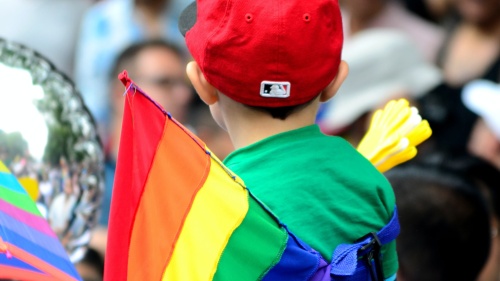 A young child at a pride parade.