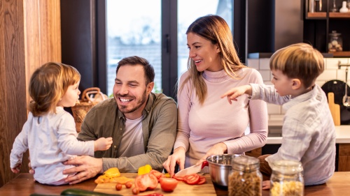 A family in the kitchen. 