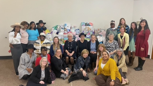 Ladies standing and seated around a table of donations