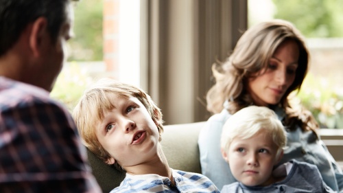 Parents talking to their young children.