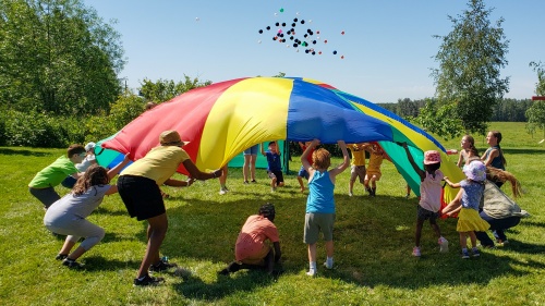 a group of children and teens playing outdoor games