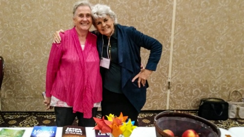 two ladies standing at the information table