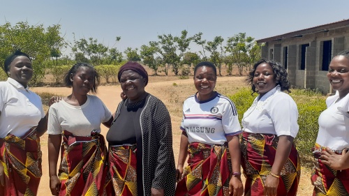 a group of women wearing matching skirts 