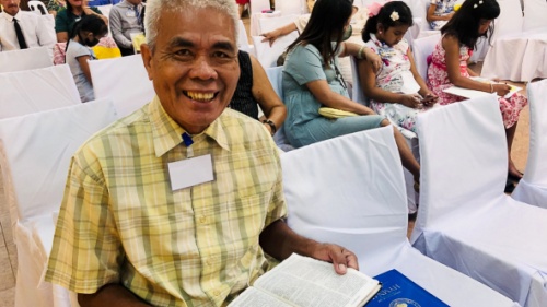 a man sitting with an open Bible