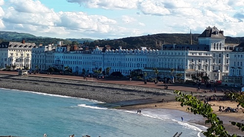 a white building with a beach in front on a cloudy day