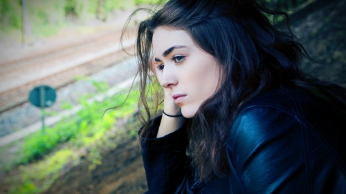 A woman looks pensively over a landscape