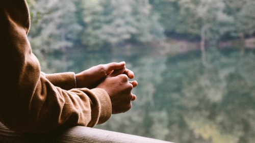 Privately praying in a serene outdoor setting