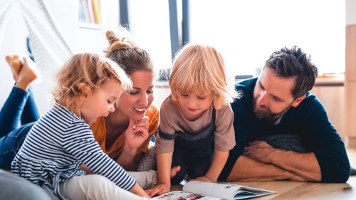 A family looking at a book.