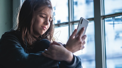 A teenager looking at her phone.