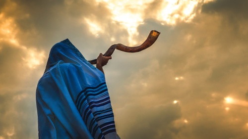 A person blowing a shofar.