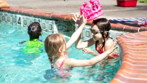 some girls playing in the swimming pool