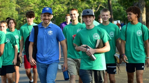 a group of teenage boys and their counselors walking outdoors