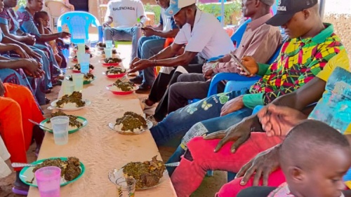 a group of people seated at a table outdoors