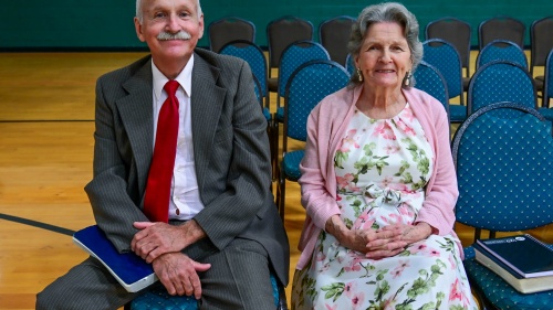 an older couple seated indoors