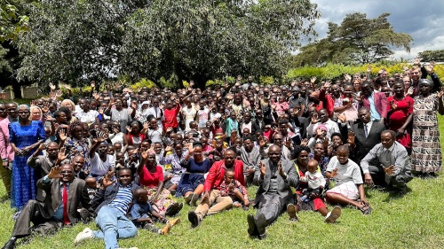 a large group of people seated outside