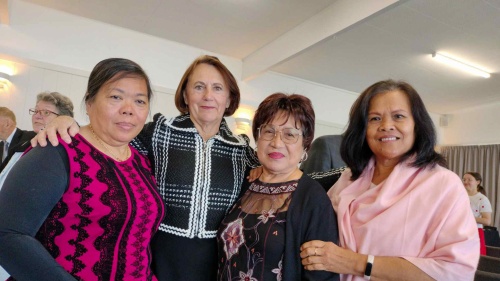 a group of four ladies standing indoors